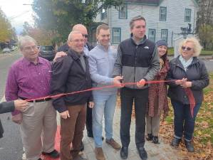 Sen. James Skoufis and Chester Town Supervisor Brandon Holdridge prepare to cut the ceremonial ribbon for the Sugar Loaf sidewalk project on Oct. 31, 2025.