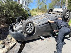 Officer Evan Metakes assisting vehicle passengers.