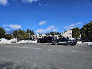 Law enforcement blocks the entrance of the Pine Hollow Way apartment complex during the February 17 investigation.