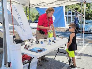 Jim Hall, NASA representative, talks to a curious passerby,