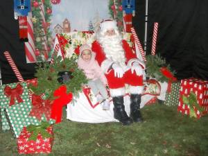 Three-year-old Valentina Pinero of Goshen was happy to sit — and talk — with Santa Claus at the Village of Goshen Tree Lighting on Dec. 4. Photos by Geri Corey.