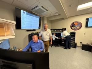 District Attorney David M. Hoovler, seated and wearing a blue shirt, with criminal investigators attached to the Orange County Digital Forensics Unit. Photo courtesy Orange County District Attorney’s office.