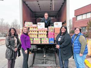 From left: Nicole Sewell, Garnet Health Medical Center’s chief nursing officer and VP of Patient Care; Moira Mencher, Garnet Health’s director of Strategic Planning and Community Relations; John Politoski, security (on the truck); Magalie Jean-Francois, Garnet Health Medical Center’s manager of Hemodialysis Unit; and Maureen Roche, Garnet Health Medical Center’s manager of Volunteer Services.