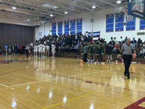 Teams huddle during a time-out at Goshen High School Varsity Basketball’s first playoff game of the season against FDR High School. Photo: Anastasia Manouvelos