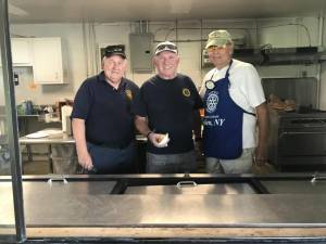Goshen Rotarians (from left) Vincent McCormack, Pat Foley, and Harry Grout prepare to feed the masses at Community Day.