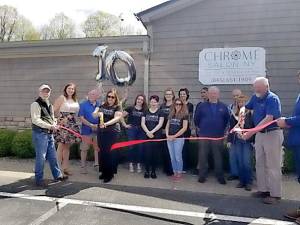 Helping with the Tenth Anniversary of Chrome Salon ribbon cutting on May 11 were Warwick Town Supervisor Mike Sweeton, Trustee Alyssa w. Jahrling, Chamber President Jan Jansen, Chrome Salon staff and chamber members.