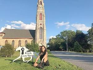 Nova Bernal-Portela with her Painted Trotter on the lawn of the First Presbyterian Church in Goshen.