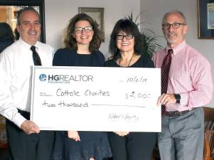 From left: Ronald Garafalo, president, Hudson Gateway Association of Realtors (HGAR); Shannon Kelly, chief operating officer, Catholic Charities of Orange, Sullivan, and Ulster; Amanda Martinez, HGAR member; and Dr. Dean Scher, chief executive officer of Catholic Charities. They're holding a ceremonial check for the presentation of a $2,000 grant from the Hudson Gateway Realtor Foundation. The funds will be used to support Catholic Charities’ community-based programs, including emergency food and shelter.