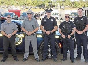Ptl. Cody Hunt represented the Village of Goshen Police Department at the annual Orange County Fair Speedway First Responders Heroes Night﻿ on Saturday, August 13. Hunt, center, is shown with NYS Troopers and Town of Wallkill Police.