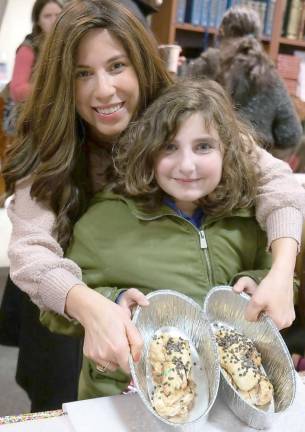 Fiana Goldenberg, 10, of Warwick, made two loaves. She is pictured with Chana Burston, who taught braiding techniques to the participating children.
