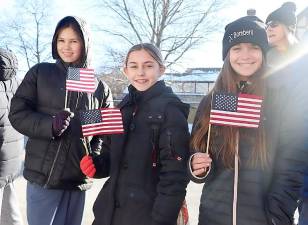 Sixth graders wait to greet the Wreaths Across America truck as it makes its way to the Orange County Veterans Memorial Cemetery.