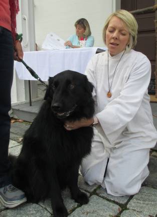 Provided photos Sugar Loaf United Methodist Church Pastor Susan Chupungco administers her blessing during last year's Blessing of the Animals. This year's service will be held on Saturday, Oct. 13.