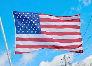 Election Day 2020 was a beautiful blue sky day. This large American flag on Route 17M in Monroe snaps proudly in the breeze. Photo by William Dimmit.