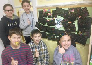 Ema Thomas, Zalmen Borenstein, Ian and Max Mayer and Brenan Neusch in front of the Gam Zu Letovah Positivity Board