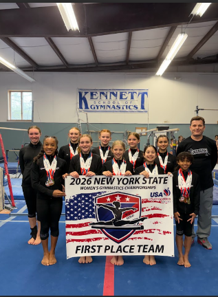 Kennett Xcel Gold team. Front (L to R) – Kennedy Vidal, Eleanor Avener, Haisley Sharp, Darla Gautier and Alyssa Abreu. Back (L to R) – Abby White, Ava Brendel, Hailey Della Monica, Fiona Trowell, Emily Thorson and Coach John Smales.