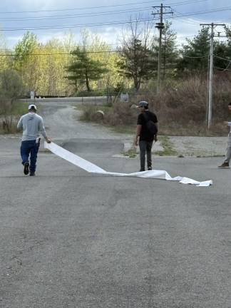 A commercial vehicle driver walks away with an unrolled stack of tickets.