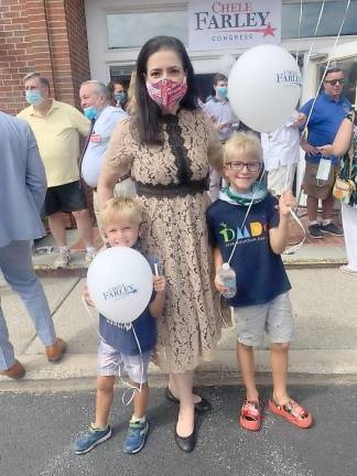 Although these two lads might be too young to voter, they nevertheless struck a poise with Congressional candidate Chele Farley at the opening of her campaign office in Goshen.