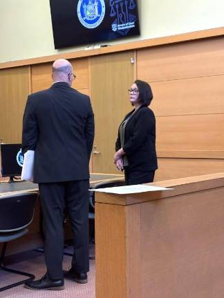 Selina Nelson-Reilly speaks to her attorney April 10 in county court.