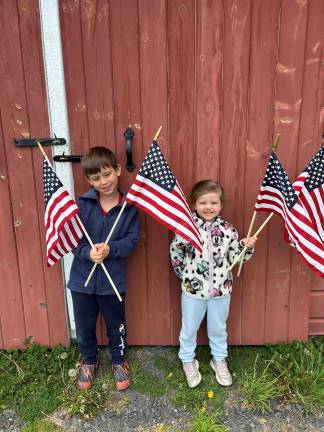 Leo (left) and Noelle DiMontova proudly hold their flags.