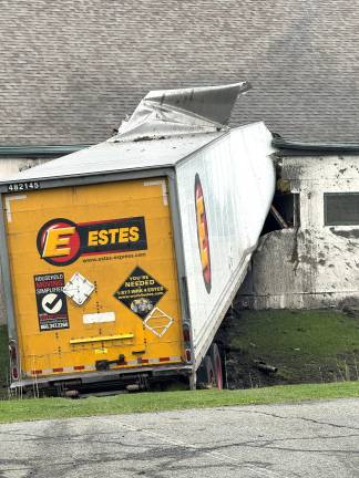 A tractor-trailer traveling south on Hatfieled Lane lost control and struck a fire hydrant, utility box and building.