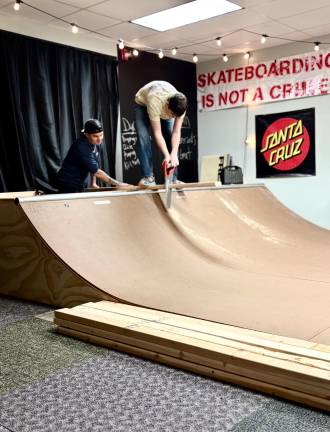 Josh Butterworth and Craig Kalucki work on a skateboard ramp at Inner Piece Rising Mentoring and Coaching in Goshen, N.Y. Photo provided by Jackie Onorato.