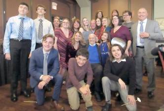 Lou Covello, in blue sweater, surrounded by younger members of his family