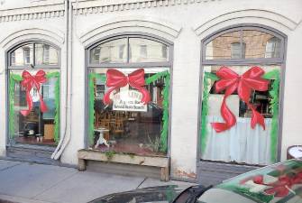 Each year, Chester Village Mayor Tom Bell coordinates holiday window painting with the business owners on Main Street and Chester Academy art students. Photos by Marie Kriner.