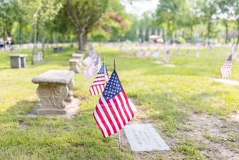 Flags along the fallen in the Veterans Memorial Cemetery in Goshen, NY. Photo by Sammie Finch