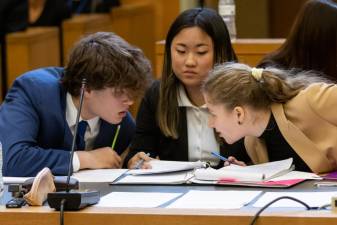 Goshen High School’s Judah Gordon, Jolina Dong and Michelle Gukham confer during a break in the finals of the Orange-Ulster BOCES Division of Instructional Support Services’ Mock Trial competition on Tuesday, March 28, at the Orange County Courthouse in Goshen.