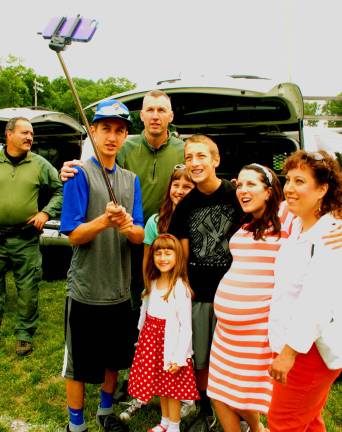 The Motz family holds a selfie stick to take a family picture: Officer Johnny Motz, a tactical operator with the Town of Chester Police (center back), and Teresa Motz (far right) with children Makenzie, 6, Jacob, 15, Mikaela, 9, and Jared, 13; Danielle Harsley, aunt, is second from right. (Photo by Ed Bailey)