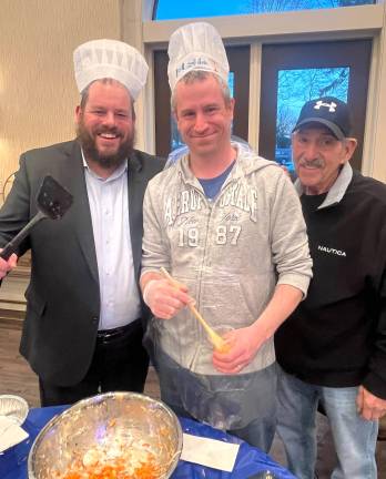 Rabbi Pesach Burston makes traditional potato latkes with Eric Benezra and Steve Reich at Chabad’s “Latke Sizzle” event.