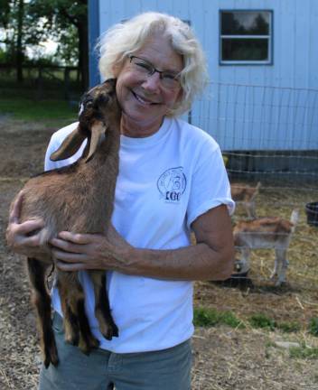Go Goats Milk Farm owner Lisa Gromacki with one of her kids.