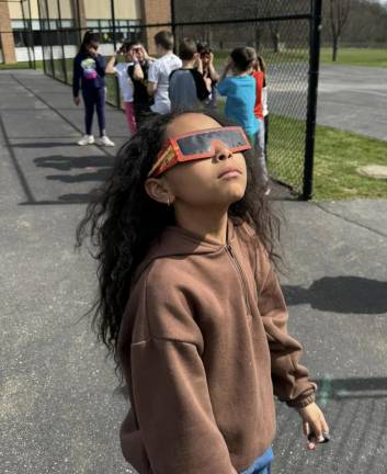 Chester Elementary School students watched as the moon blocked light from the sun.