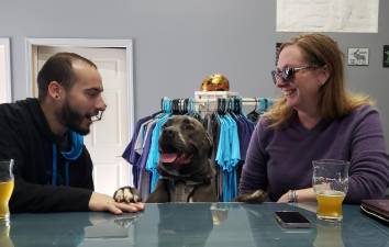 Nicholas Bradner, Colleen Monaghan and pup Tobra enjoy a couple of pints to celebrate Apex Brewery’s one year anniversary. Photo provided.