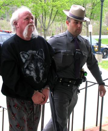 A New York State tropper escorts Charles M. Sawtelle, 53, of Westbookville, into Warwick Town Court, where he was arraigned on charges of second-degree conspiracy and fifth-degree criminal possession of a controlled substance.