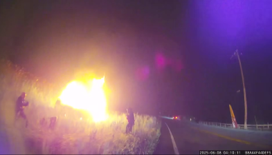 Emergency personnel at the scene of a burning upside down vehicle off Kings Highway in Chester June 8.
