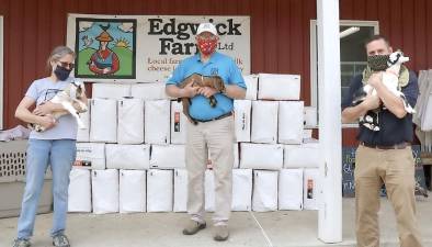 Orange County Executive Steven M. Neuhaus, on the right, with Talitha and Dan Jones at Edgwick Farm in Cornwall last month. Edgwick Farm will return to the Goshen Farmers Market this year. The market opens Friday, May 29. Provided photo.