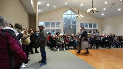 Crowds turned out for the April 18 public hearing about Neil Gold’s dinosaur park, filling the room and standing when there were no available seats left. Photo: Sharon Scheer