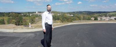 Builder Livy Schwartz stands on a new road at the Greens of Chester.