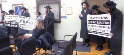 Rabbi Joel Tzimerman, Rabbi Yoel Loeb, and Rabbi Yoel Loeb's son, from the KJ Committee for Peace and Harmony, were among those carrying banners at the Dec. 11 Chester town board meeting.