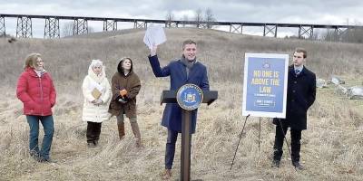 State Sen. James Skoufis holds the six state DEC stop work orders sent in May, June, July, August, September and November of 2022, prohibiting any work to proceed at the South Blooming Grove development known as Clovewood, except for steps taken to prevent soil erosion. Skoufis called for the Department of Environmental Conservation to enforce its six standing “cease and desist” directives. Photos provided by the senator’s office.