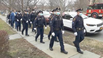 Members of the Village of Goshen Police Department file into Donovan Funeral Home on South Church Street in Goshen on March 17 to pay their respects to the family of Mayor Mike Nuzzolese. The mayor died March 13. He was 66 years old. Photo by Kate Schmidt.