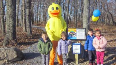 Calvin Tower, 4, Adriana Gennaro, 4, Matthew Gennaro and his twin sister, Angela Gennaro, 5, pose by the first station with the library's mascot Webster the duck