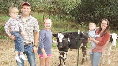 The Touw family at Wagon Wheel Farm (from left): Jason Touw, holding his son, Owen, 4; daughter Baylie, 12; and Kristin, holding son, Emmett, 16-months old.