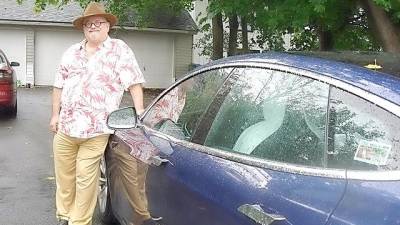 Environmentalist Michael Edelstein with his all electric car, the Tesla Model S.