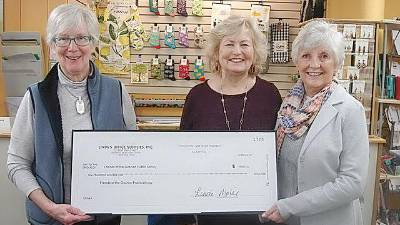 Linda Mabie, owner of Linda’s Office Supplies and Gifts, on the left, is happy to donate a check for $600 to Yvonne Mirro, center, and Mary Troy. Mirro is president of the Friends of the Goshen Library and Troy is vice-president of the Friends of the Goshen Library. The check is a portion of the proceeds from the sale of an ornament representing the new library; the latest in a series of seven ornaments.