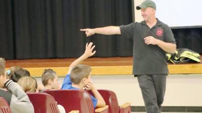 Firefighter Matteo Cirigliano speaks to fifth graders at Goshen Intermediate School.