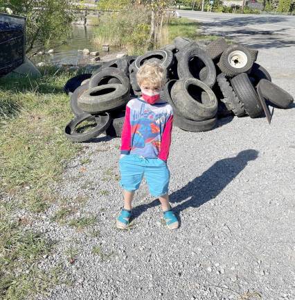 This young volunteer is left to wonder why anyone would throw used tires into Walton Lake. Last weekend Friends of Walton Lake and volunteers removed more 50 automobile tires from the lake, which is one of the few initial outflows into the Moodna Creek Viaduct. This water source flows through 14 municipalities in Orange County before it enters the Hudson River and eventually the Atlantic Ocean.