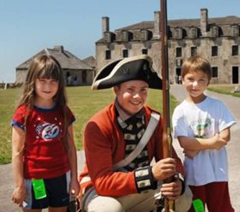 Visitors with re-enactor inside Old Fort Niagara in Youngstown, N.Y.