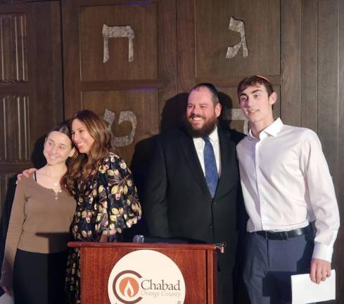 CTeen leaders Ariel Koyfman of Chester and Lola Sale of Harriman are congratulated by Rabbi Pesach and Chana Burston for their community service.
